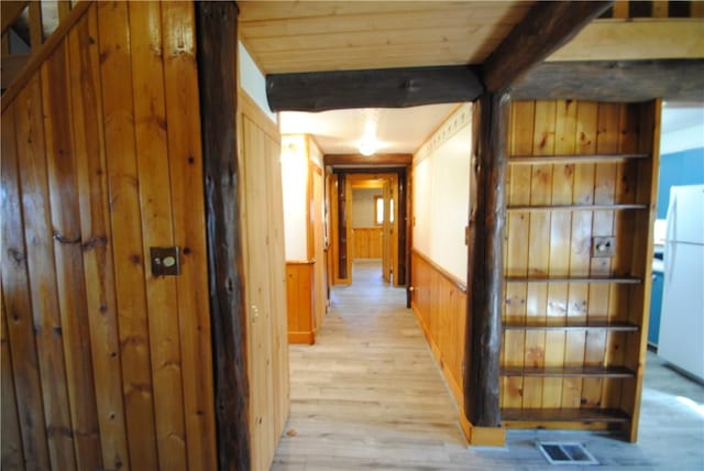 9221 Health St, North Dansville, NY 14437 - corridor featuring visible vents, wood walls, beam ceiling, light wood-style floors, and a wainscoted wall