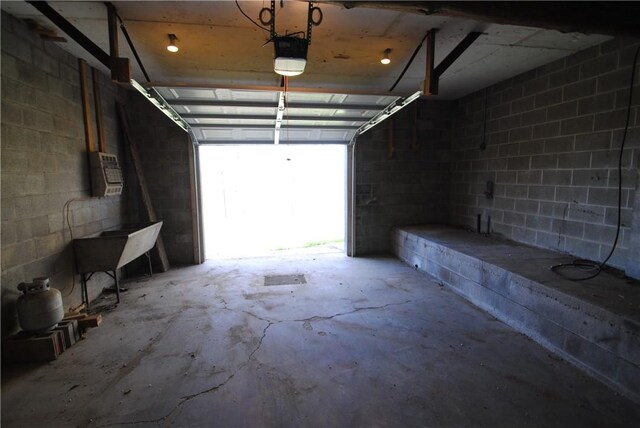 9221 Health St, North Dansville, NY 14437 - garage featuring concrete block wall and a garage door opener
