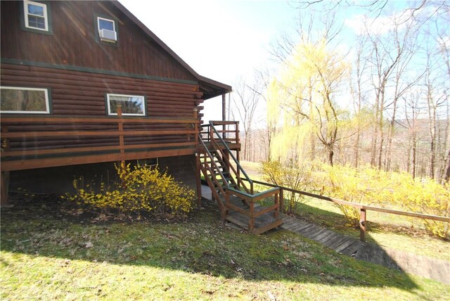 9221 Health St, North Dansville, NY 14437 - view of home's exterior with log siding, a deck, and stairway