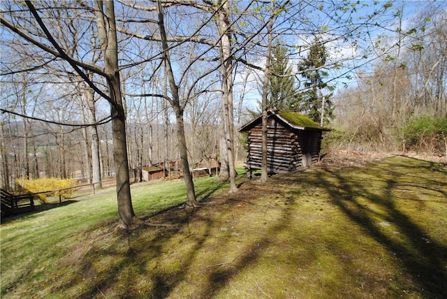 9221 Health St, North Dansville, NY 14437 - view of yard featuring fence, a wooded view, an outdoor structure, and a shed