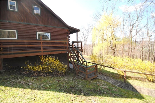 9221 Health St, North Dansville, NY 14437 - view of home's exterior with log siding, a deck, and stairway