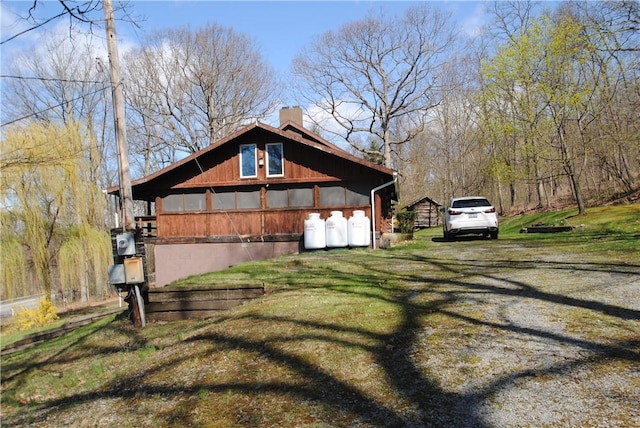 9221 Health St, North Dansville, NY 14437 - view of side of home featuring a lawn and a chimney