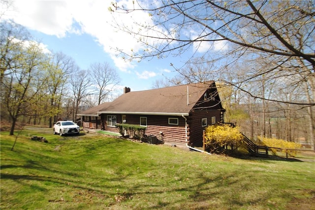 9221 Health St, North Dansville, NY 14437 - view of home's exterior featuring a yard, a barn, log exterior, and a chimney