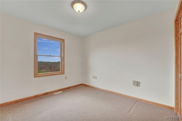 carpeted empty room with baseboards and visible vents