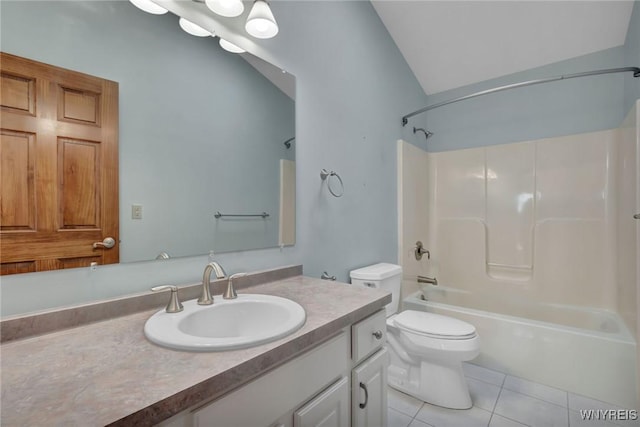 full bathroom with lofted ceiling, tile patterned floors, toilet, vanity, and tub / shower combination