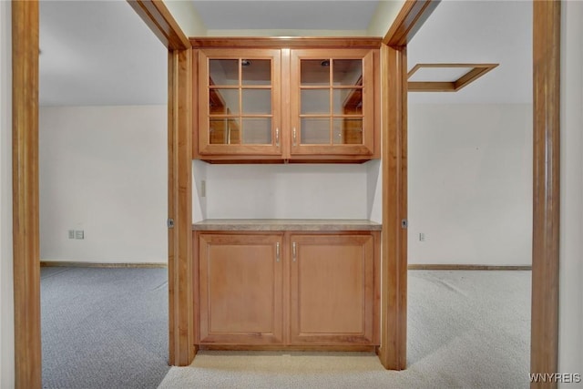interior space with carpet and baseboards