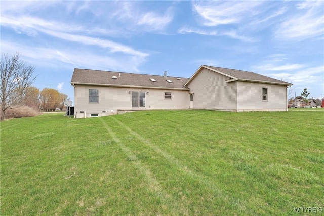 rear view of property with a yard
