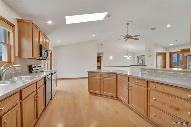 kitchen featuring a sink, tasteful backsplash, light wood-style floors, light countertops, and appliances with stainless steel finishes