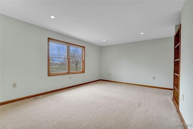 carpeted empty room with recessed lighting, visible vents, and baseboards