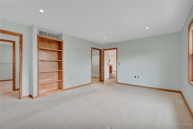 unfurnished bedroom featuring recessed lighting, visible vents, baseboards, and light carpet