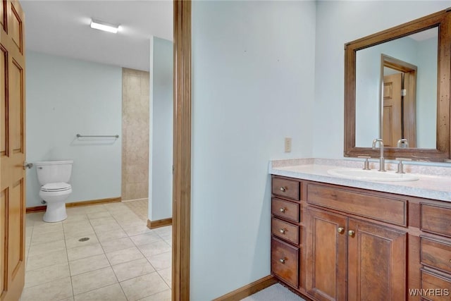 bathroom featuring tile patterned flooring, baseboards, toilet, and vanity