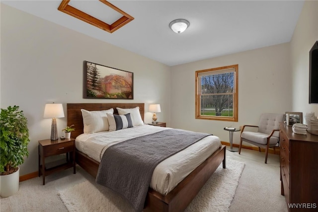 bedroom featuring baseboards and light colored carpet