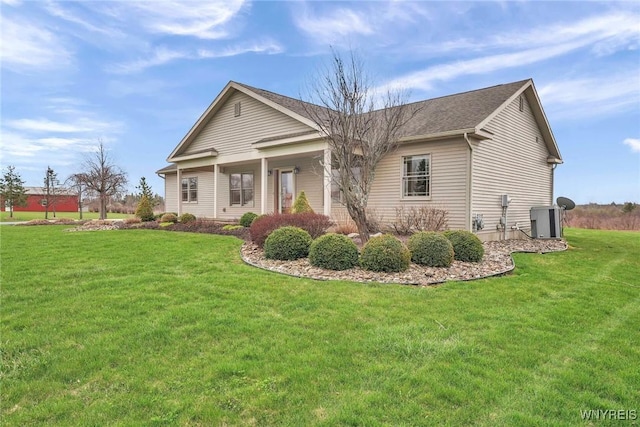 view of front of property featuring a front lawn and cooling unit