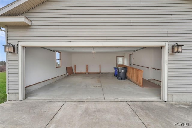 garage featuring concrete driveway