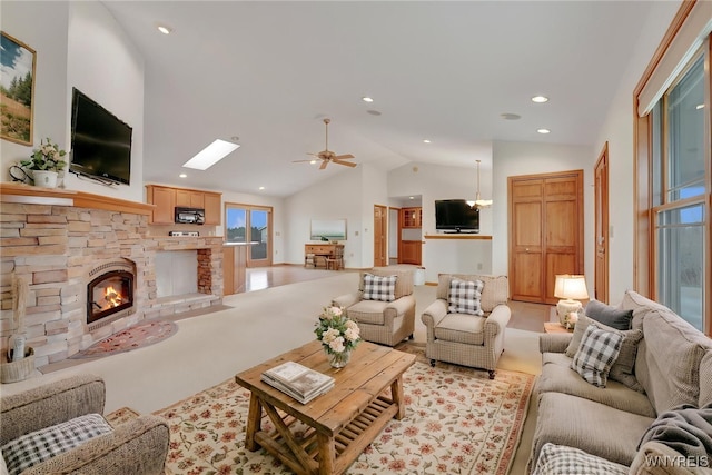 living area with recessed lighting, vaulted ceiling, a ceiling fan, and a fireplace