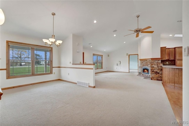 unfurnished living room featuring recessed lighting, visible vents, light carpet, baseboards, and ceiling fan with notable chandelier