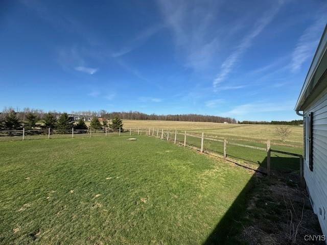 view of yard featuring a rural view and fence