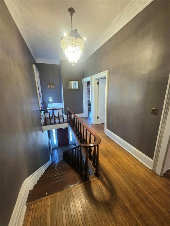 408 W Water St, Elmira-City, NY 14905 - stairway with hardwood / wood-style flooring, baseboards, a notable chandelier, and crown molding
