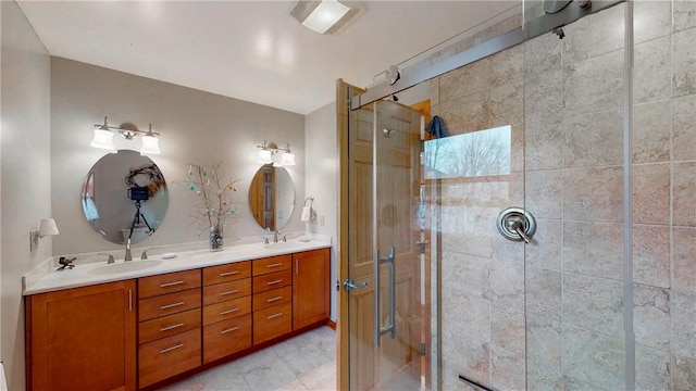 bathroom featuring a sink, double vanity, and a stall shower