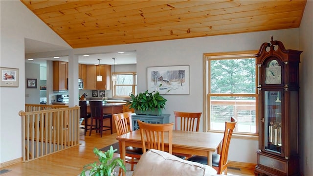 dining room with lofted ceiling, light wood-style flooring, visible vents, and wood ceiling