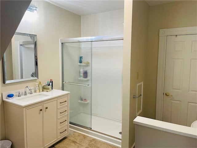 bathroom featuring a shower stall and vanity