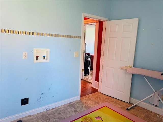clothes washing area with washer hookup, baseboards, and laundry area