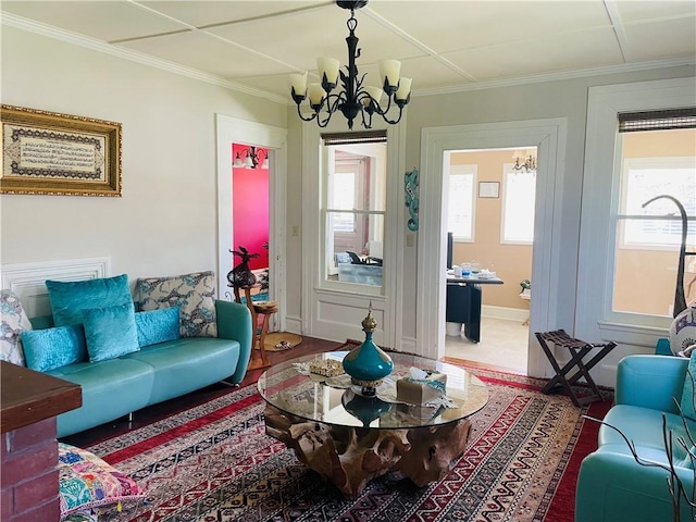 living room featuring an inviting chandelier and crown molding