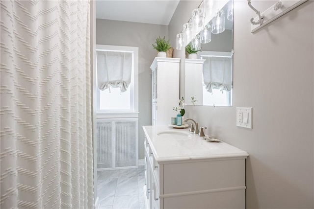 bathroom featuring marble finish floor and vanity