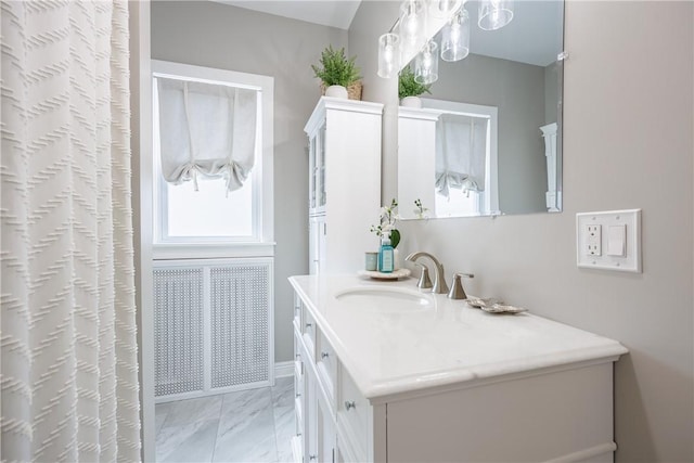 full bath with marble finish floor, a shower with curtain, and vanity