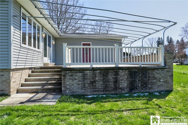exterior space with a lawn and a wooden deck