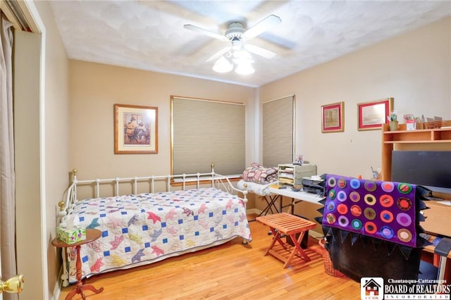 bedroom with a ceiling fan and wood finished floors