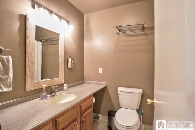 bathroom with toilet and vanity