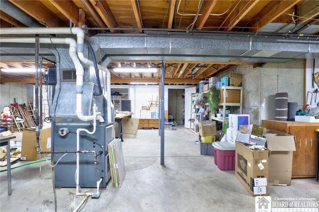 unfinished basement with heating unit and visible vents