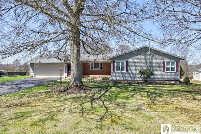 ranch-style home with a garage, driveway, and a front yard
