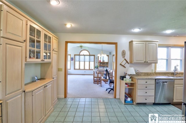 kitchen with light countertops, dishwasher, a ceiling fan, glass insert cabinets, and light colored carpet