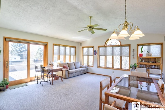 living area featuring vaulted ceiling, a textured ceiling, carpet flooring, and a wealth of natural light