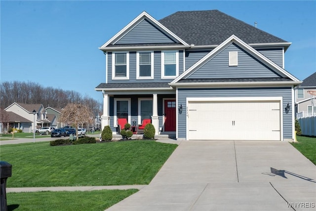traditional home with a garage, driveway, a front yard, and covered porch