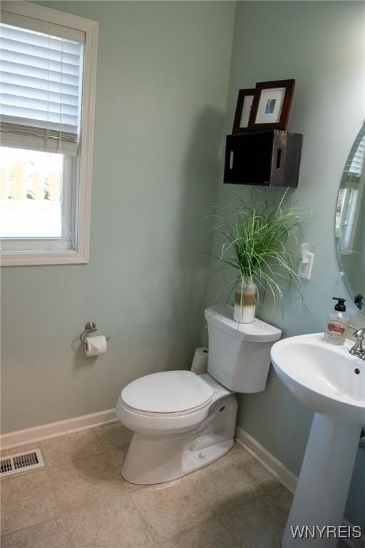 bathroom with visible vents, toilet, baseboards, and tile patterned floors
