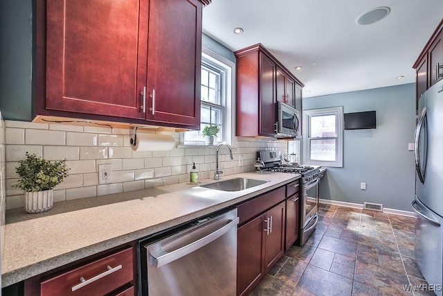 35 University Ct, Amherst, NY 14226 - kitchen with dark brown cabinets, appliances with stainless steel finishes, and a sink
