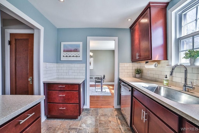 35 University Ct, Amherst, NY 14226 - kitchen with stainless steel dishwasher, a sink, dark brown cabinets, decorative backsplash, and light countertops