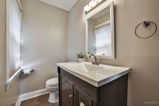 35 University Ct, Amherst, NY 14226 - bathroom with baseboards, toilet, and vanity