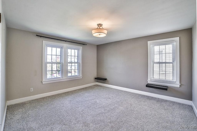35 University Ct, Amherst, NY 14226 - carpeted empty room with baseboards
