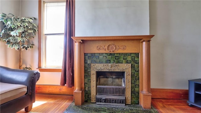 living area featuring a tile fireplace