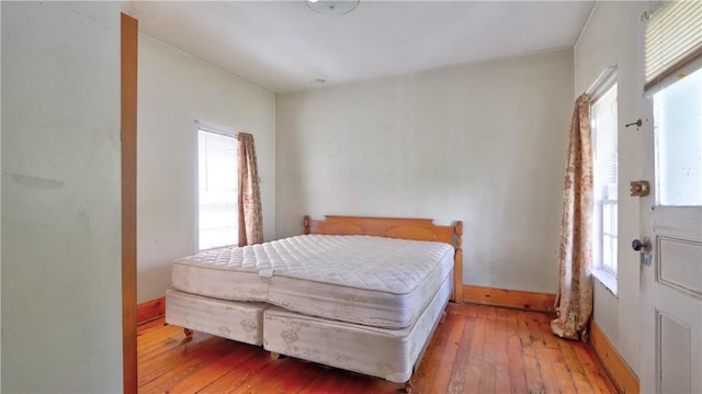bedroom featuring light wood-style flooring and baseboards