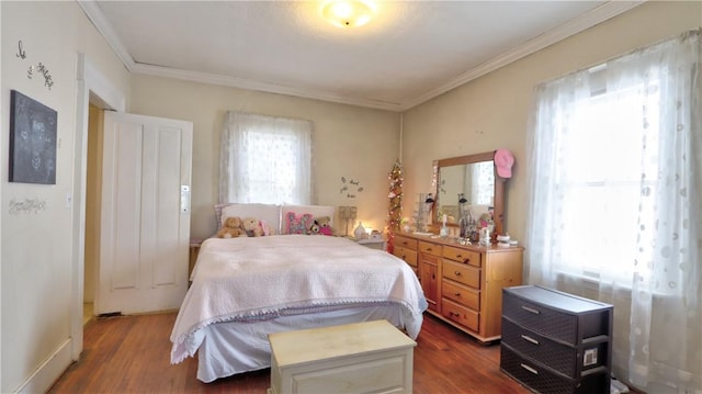 bedroom with wood finished floors and ornamental molding