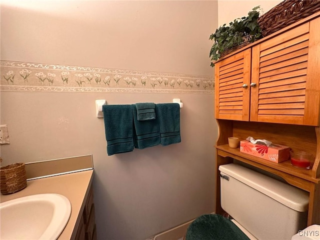 half bathroom with vanity and toilet