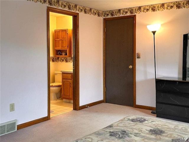 bedroom featuring connected bathroom, light carpet, visible vents, and baseboards