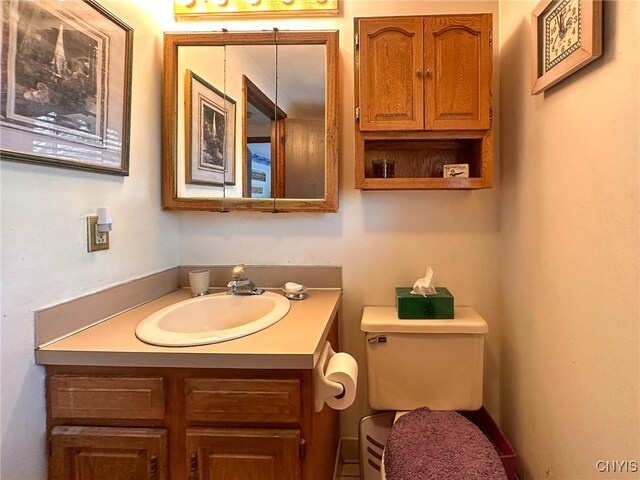bathroom featuring vanity and toilet