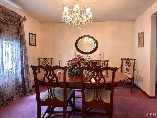 dining space with an inviting chandelier, carpet flooring, and baseboards