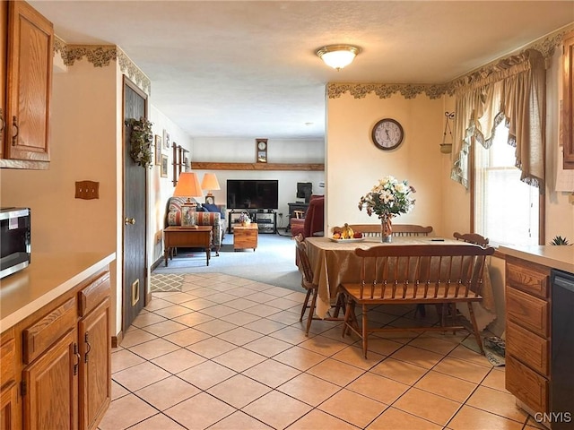 dining room with light colored carpet and light tile patterned flooring
